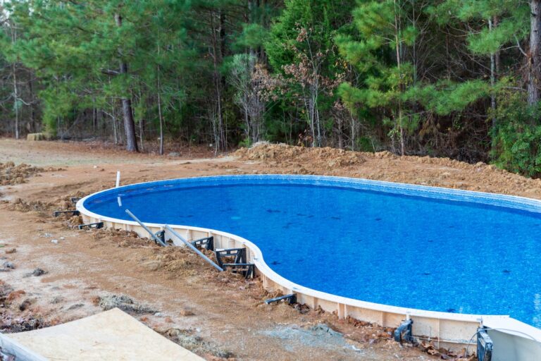New swimming pool being installed in a back yard